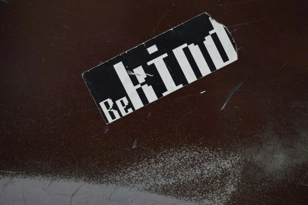 sticker on wall that says "Be Kind"