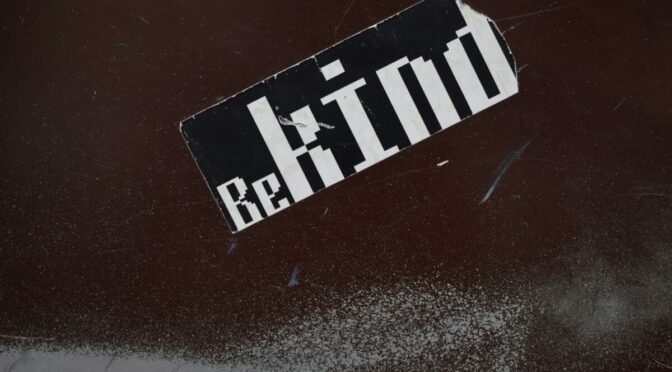 sticker on wall that says "Be Kind"
