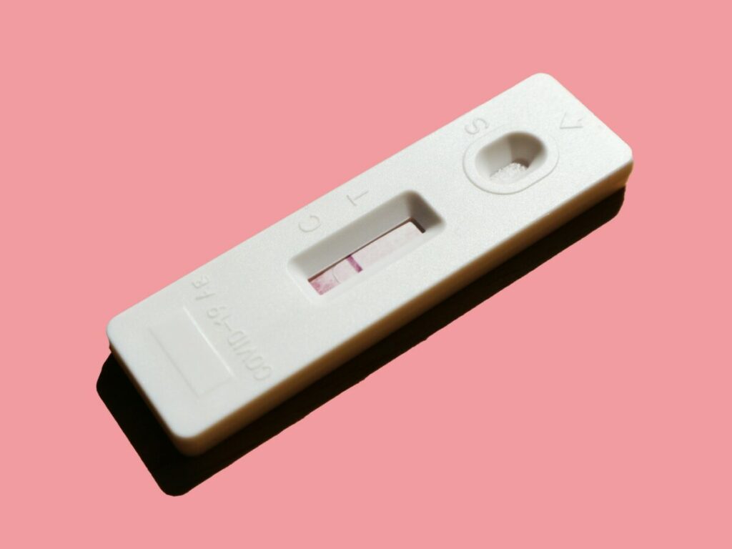 Photo of pregnancy test on pink background