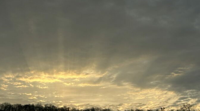 Photo of sun breaking through clouds