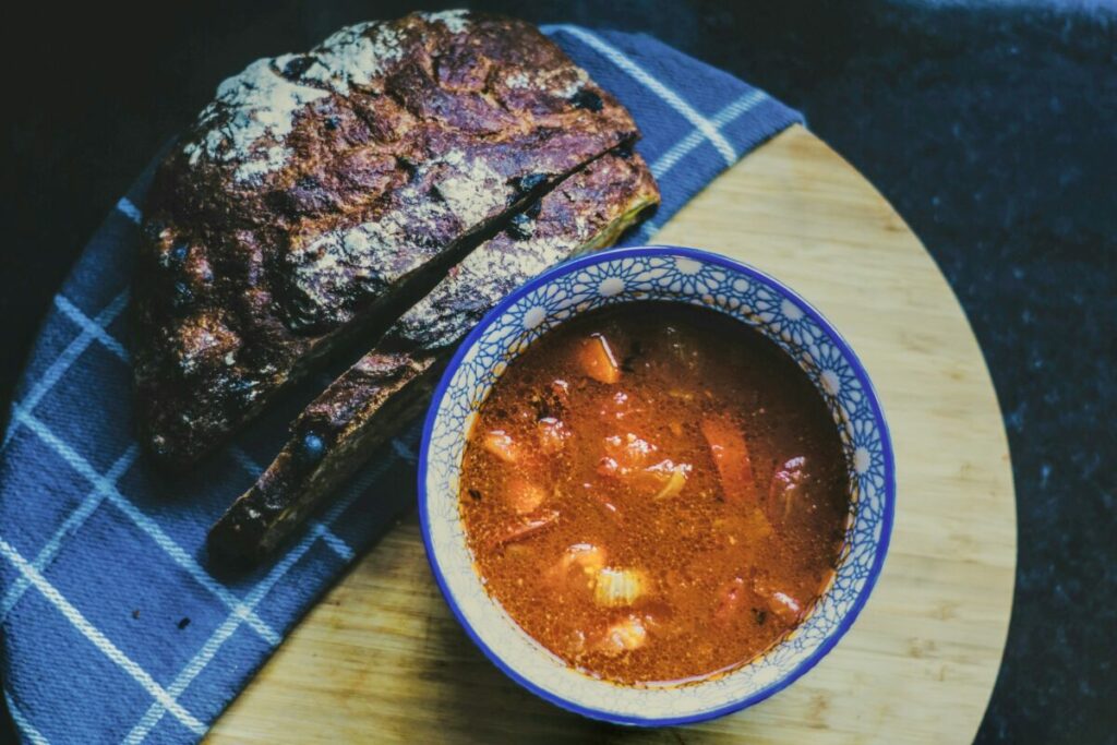 soup and bread on blue checkered napkin