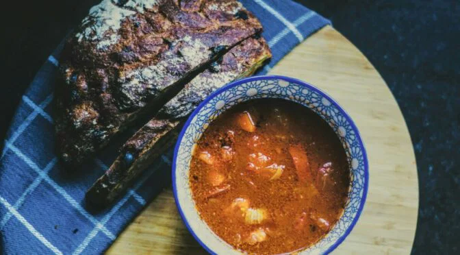 soup and bread on blue checkered napkin