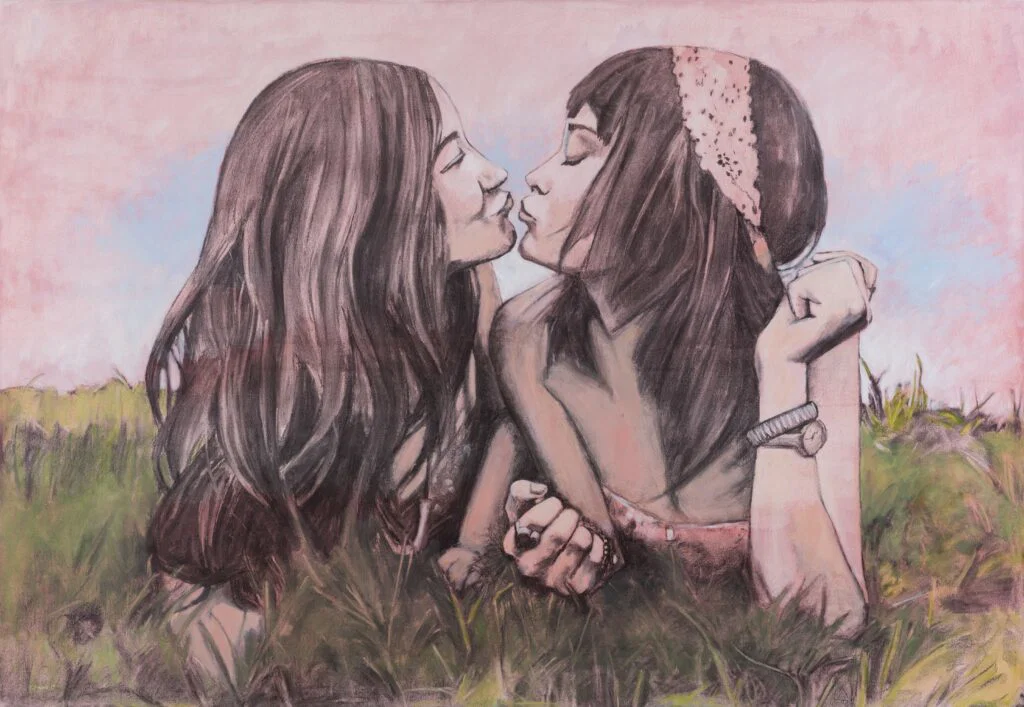 Two young women, laying in field, about to kiss