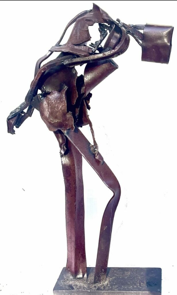 Sculpture of humanoid bent over
