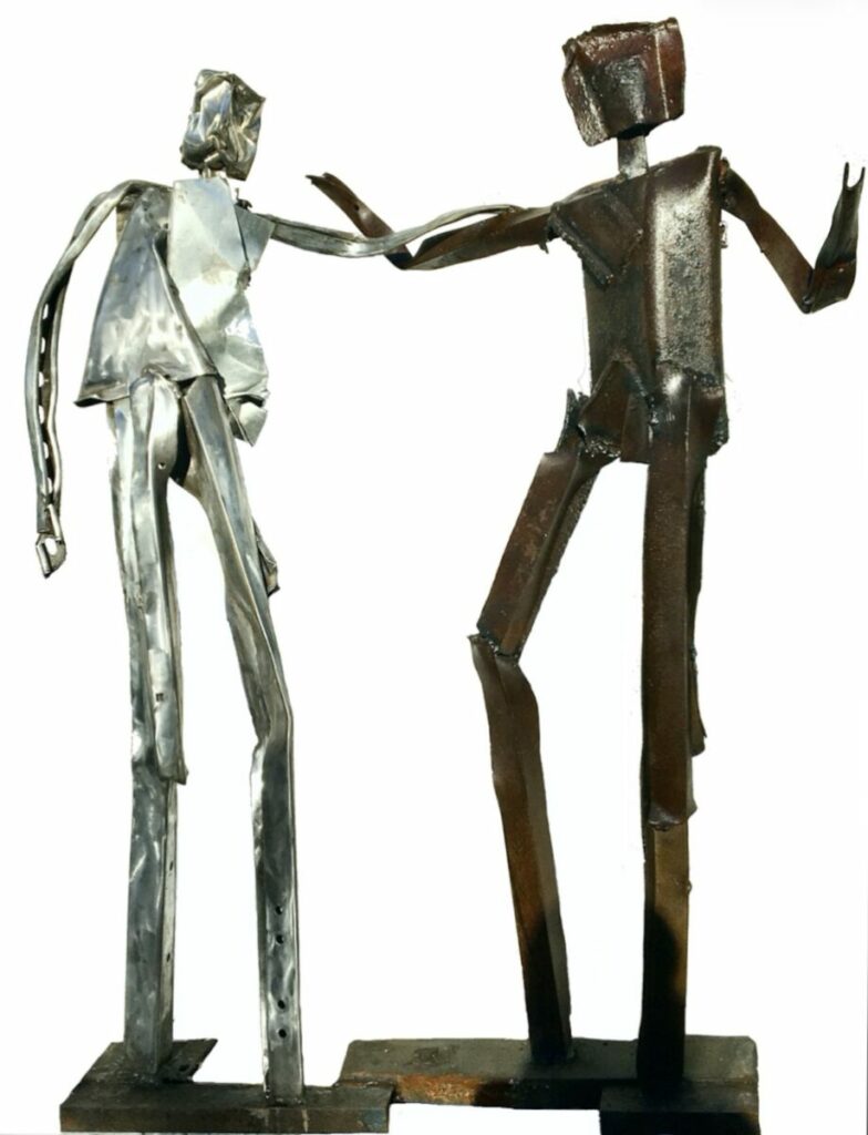 Sculpture of two figures, hands entwined