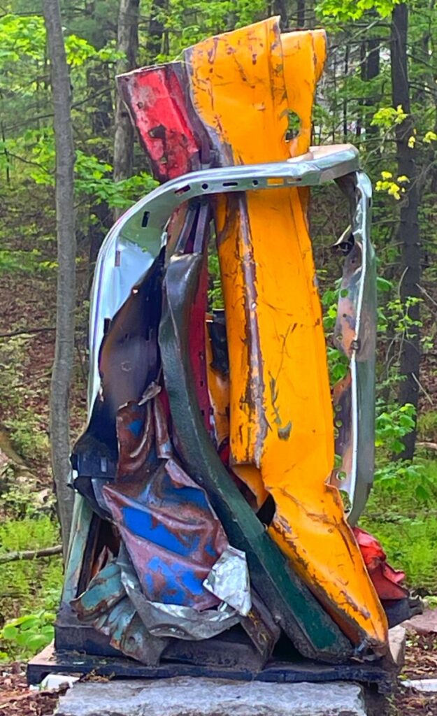 Abstract sculpture of two colored rectangles hugging