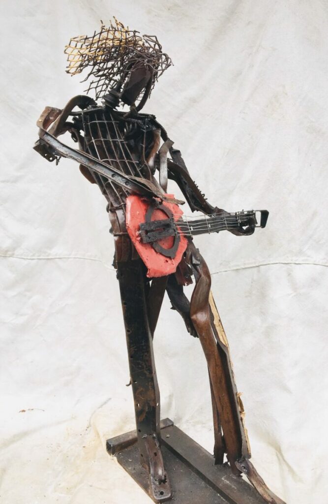 Sculpture of person playing guitar