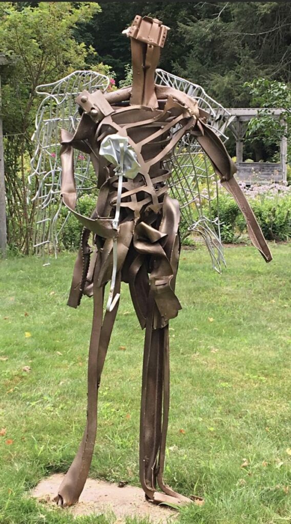 Sculpture of humanoid with wings