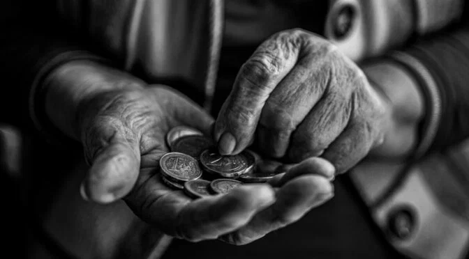 Black and white photo of hands holding coins
