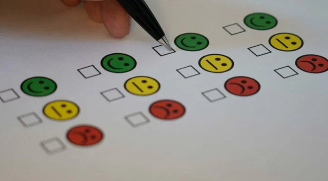 Picture of a checkmark options under emojis, smiling, sad and in between