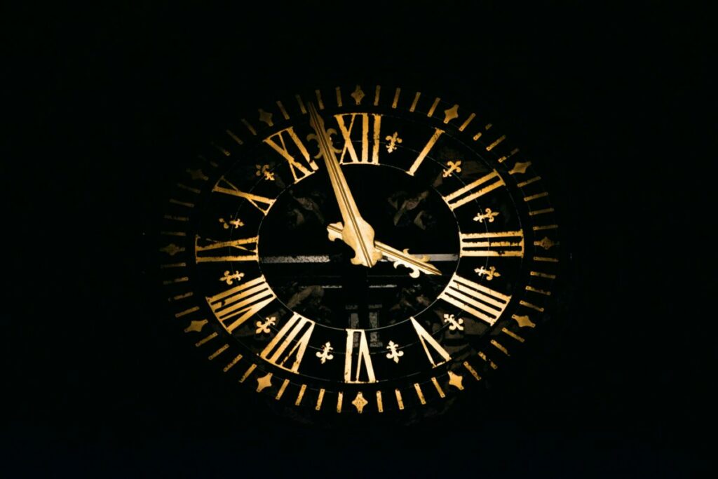 Photo of large clock face with gold numbers and hands