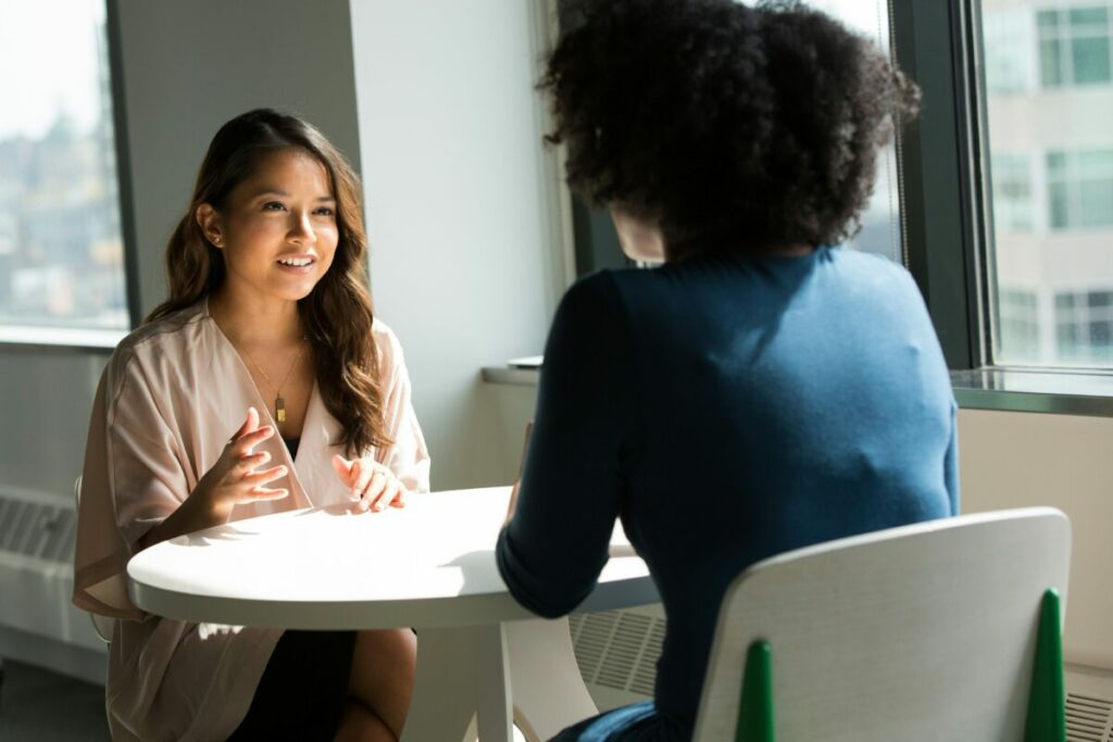Photo of two women sitting across a table from each other